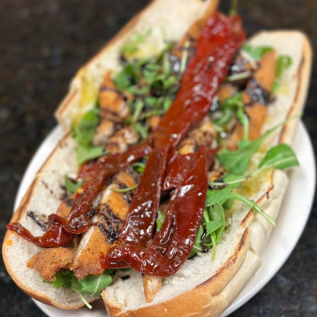 New Chicken Hero fresh Mozzarella, Sundried Peppers, Arugula, Balsamic Glaze.
